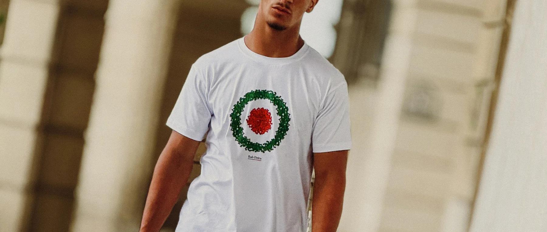 A young man wearing a Bab Dzira T-shirt overlooking the Bay of Algiers